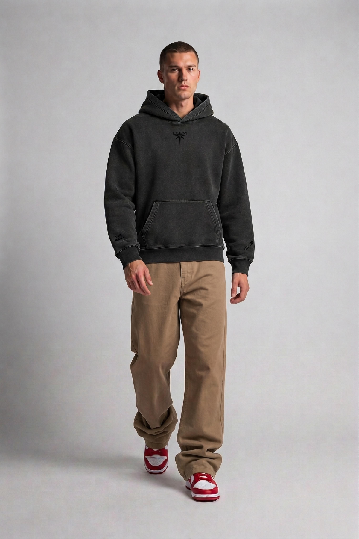 Model wearing the Bandana Vintage Hoodie in garment-dyed black, front view with tonal DEEM chest logo